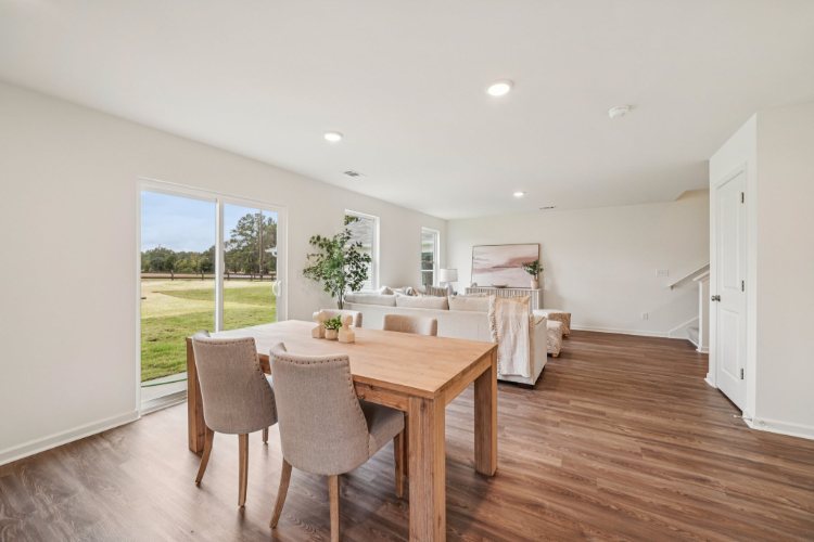 A dining room with a wood floor.