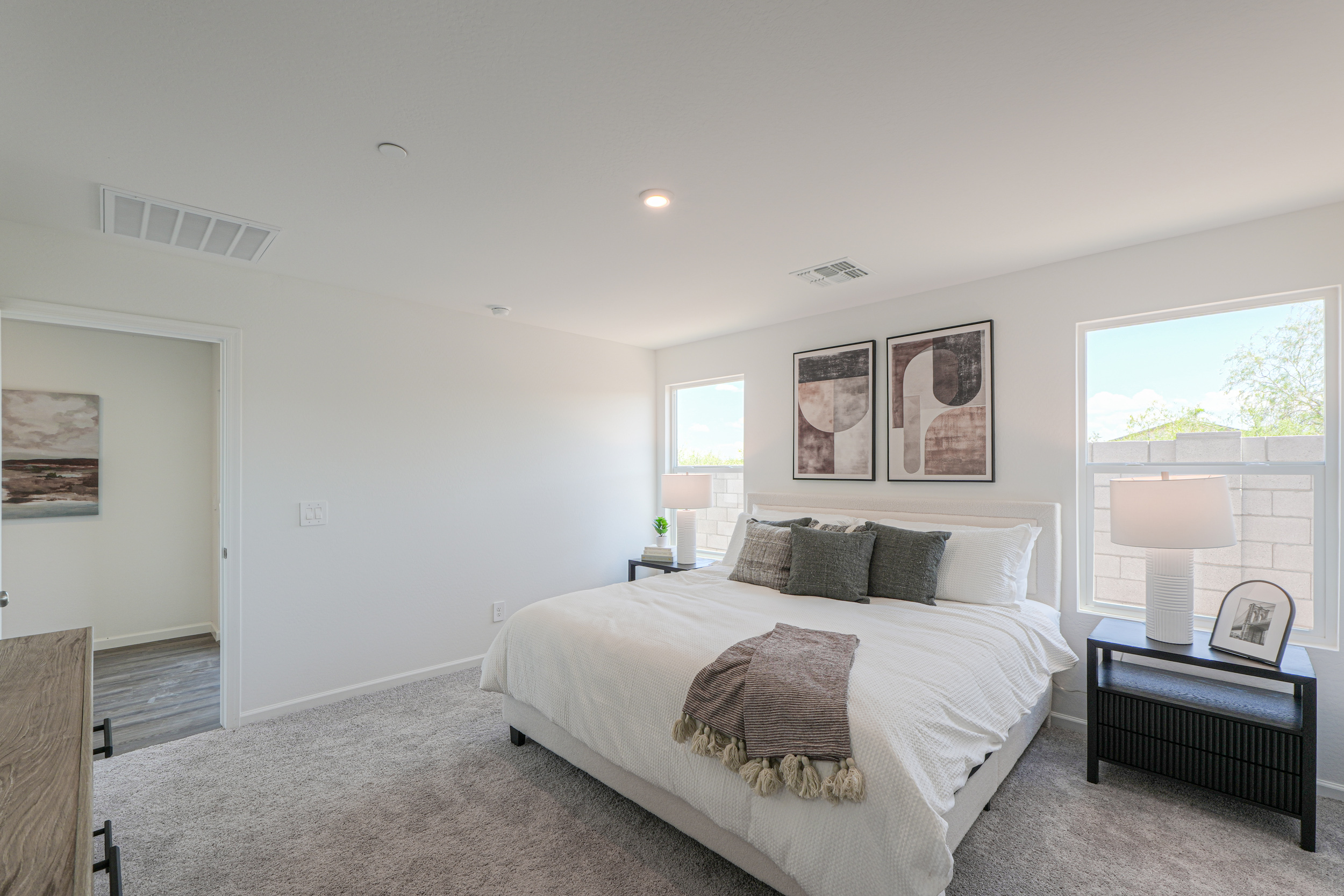 A bedroom with a bed and a table.