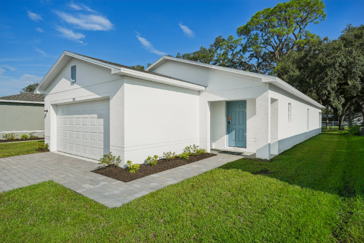 A white house with a driveway.