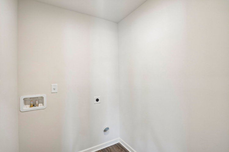 A white wall with a light switch.