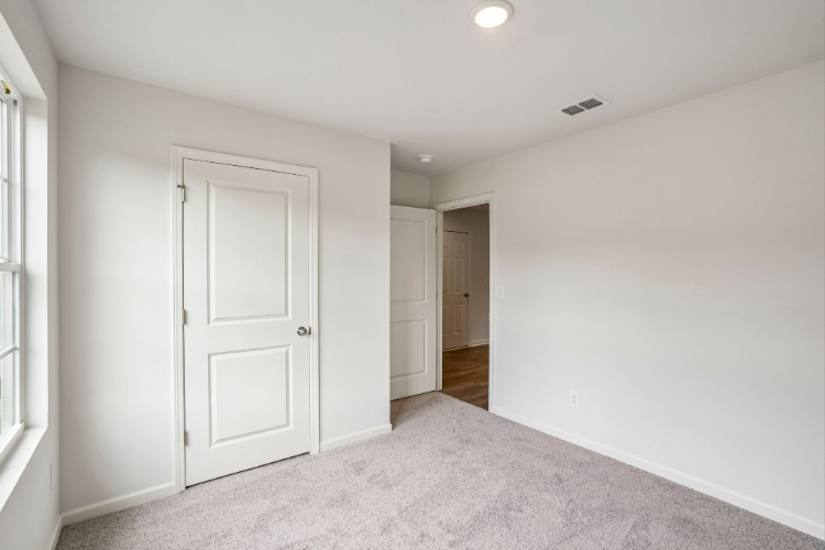 A hallway with white doors.