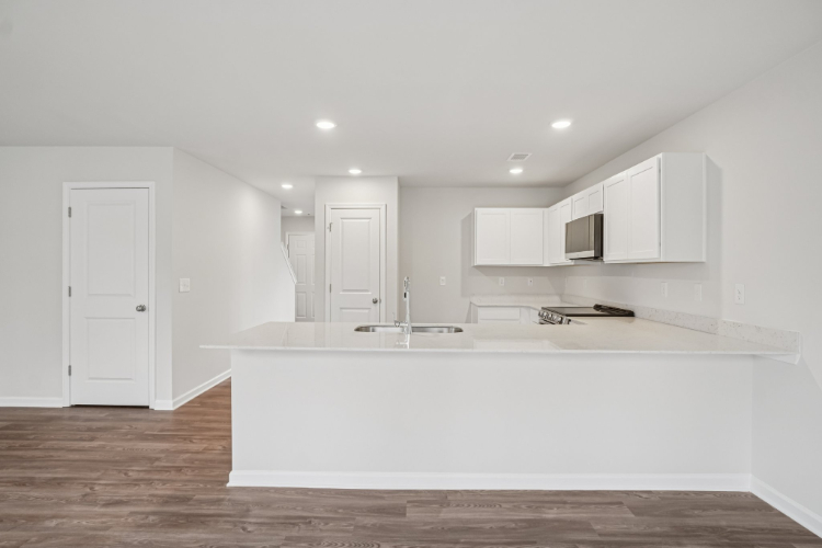 A white kitchen with white cabinets.