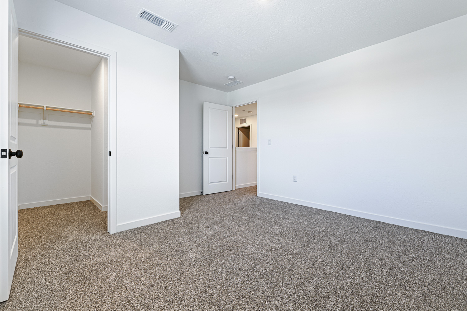 A hallway with white doors.
