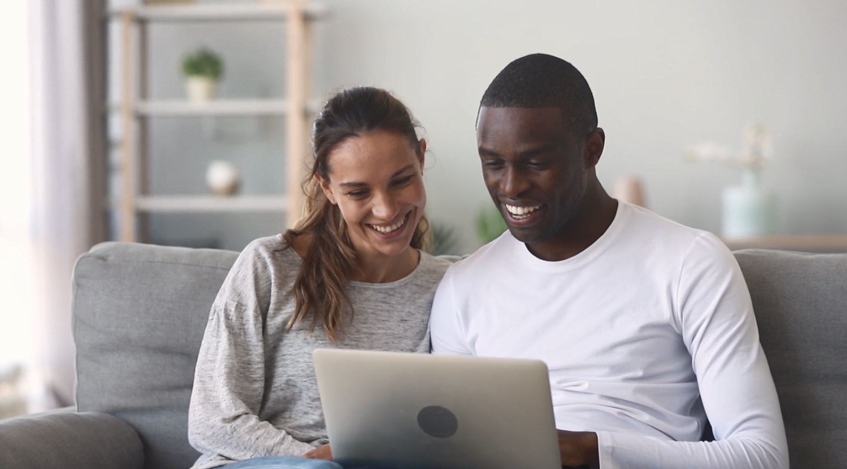A man and a woman looking at a laptop.